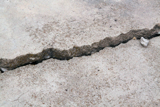 Cracked concrete surface needing restoration for safety and property value.