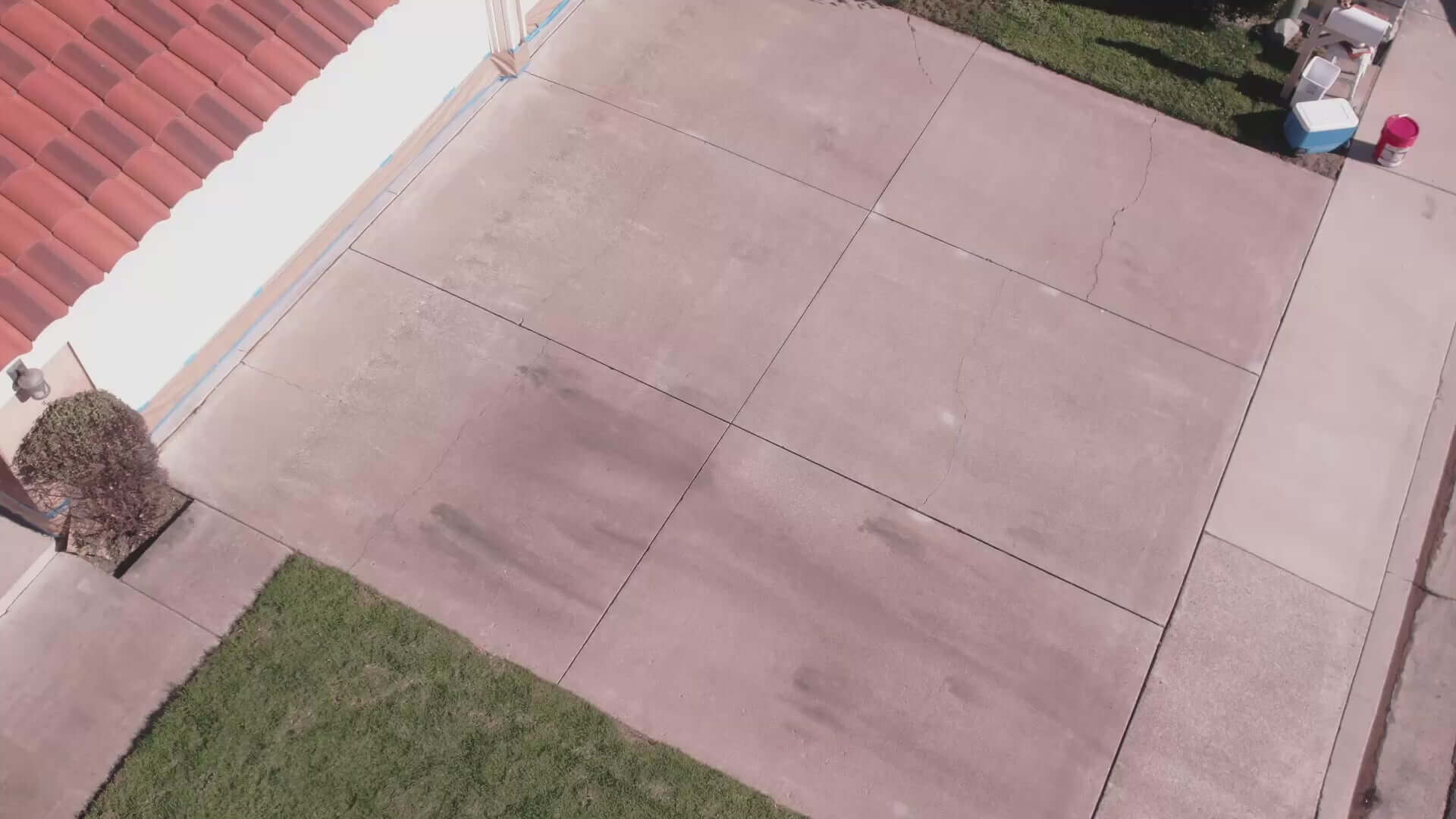 Aerial view of a concrete driveway showing stains and wear, ideal for Like-Nu Concrete Restoration Kit application.