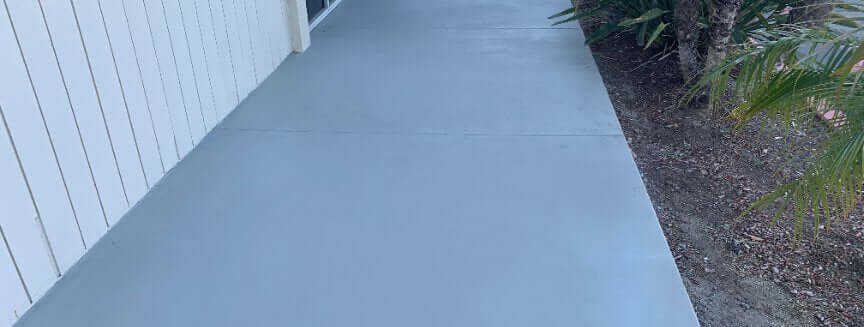 Contractor spraying Like-Nu concrete mix onto a cracked driveway during a resurfacing job