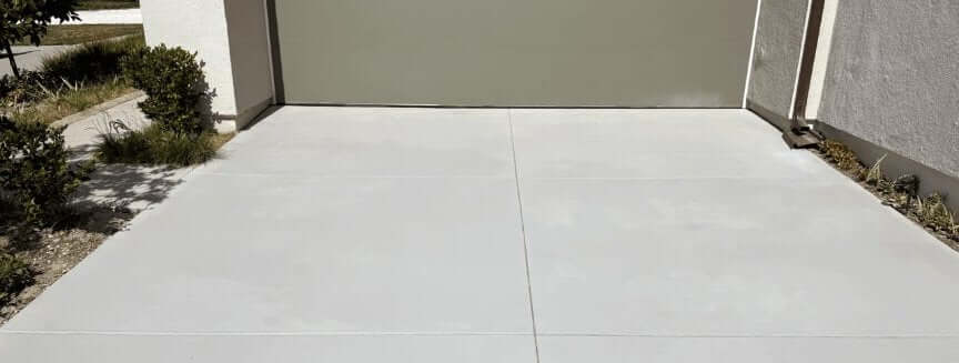 Side-by-side comparison of a traditional concrete overlay edge lifting versus a spray-on concrete finish bonded flush to the slab