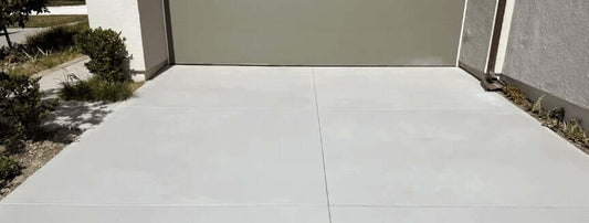 Side-by-side comparison of a traditional concrete overlay edge lifting versus a spray-on concrete finish bonded flush to the slab