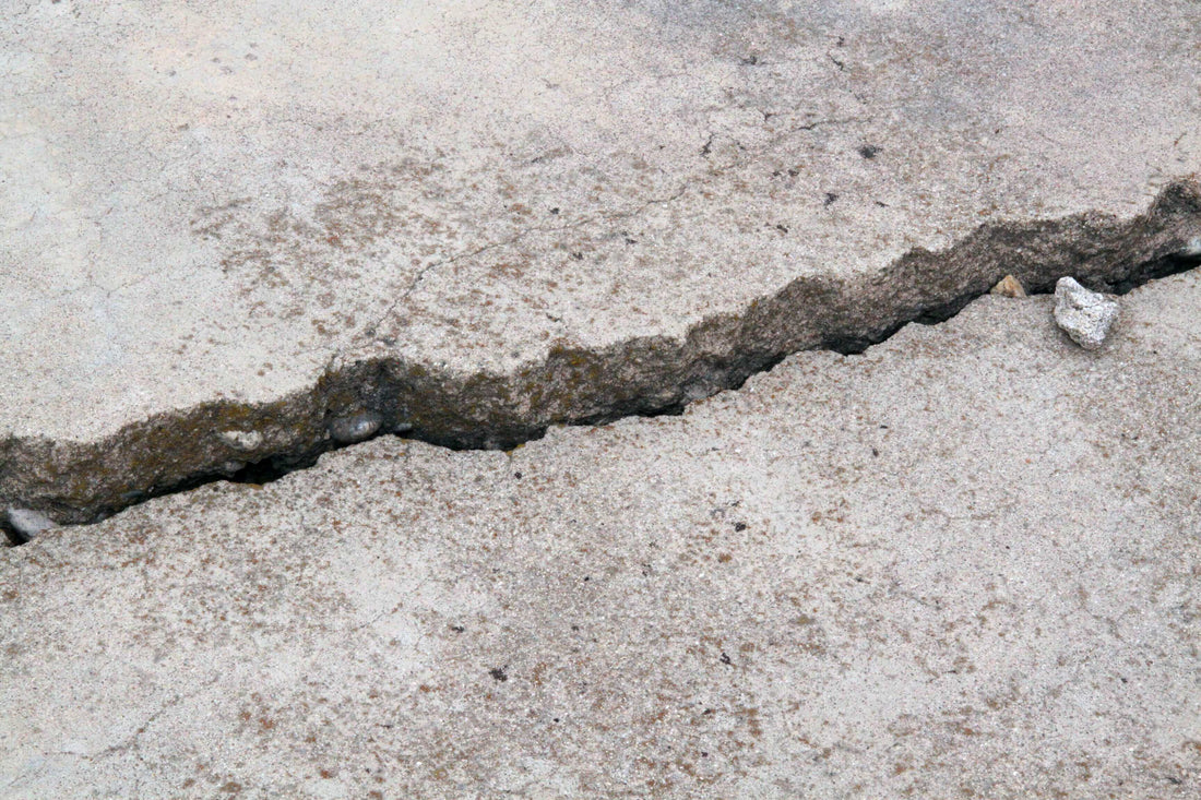 Cracked concrete surface needing restoration for safety and property value.