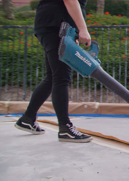 Person using a Makita tool to prepare the surface for Like-Nu Concrete Restoration Kit