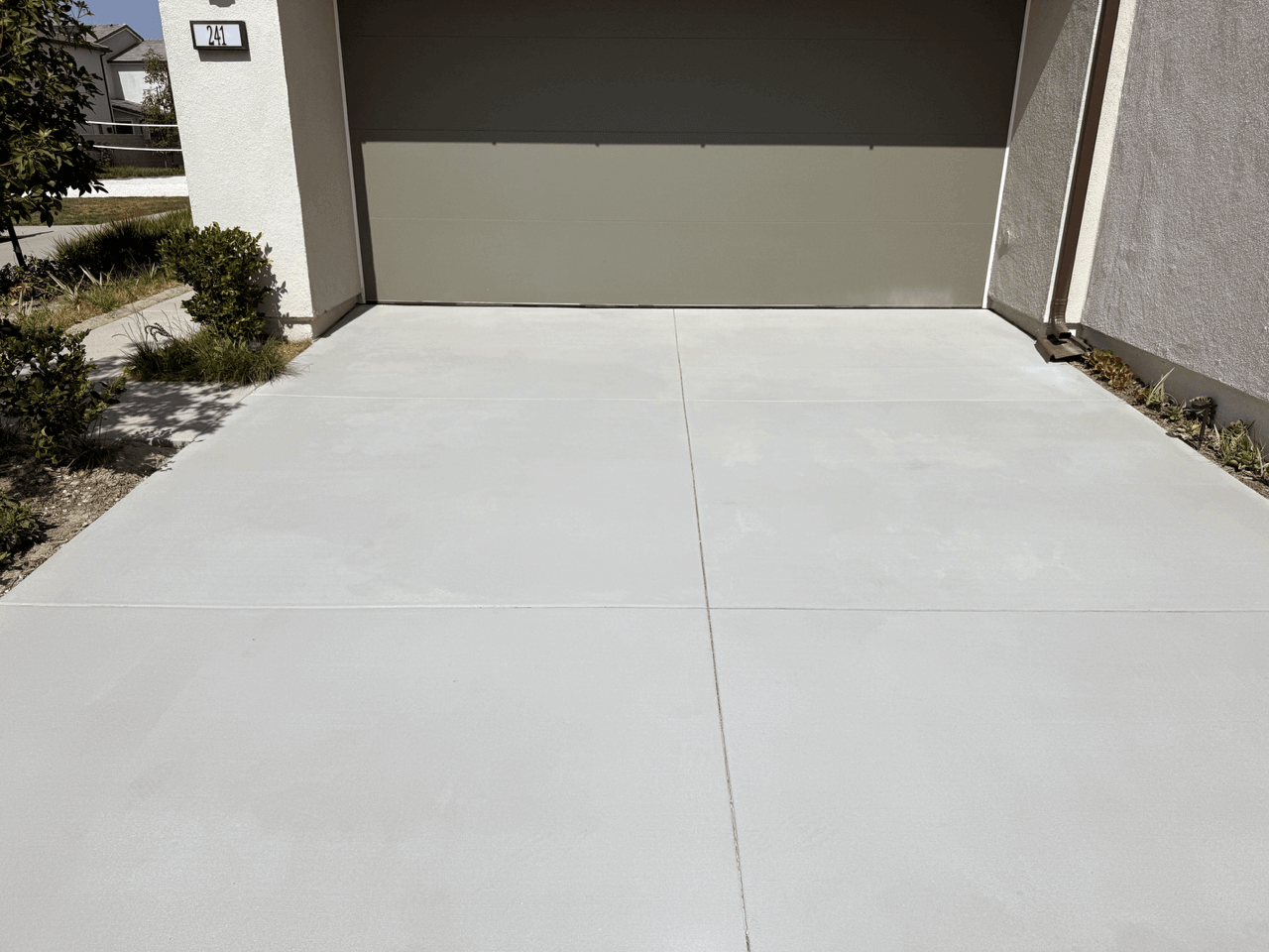 Clean concrete driveway free of oil stains, showcasing the effectiveness of Like-Nu Oil Stain Remover.