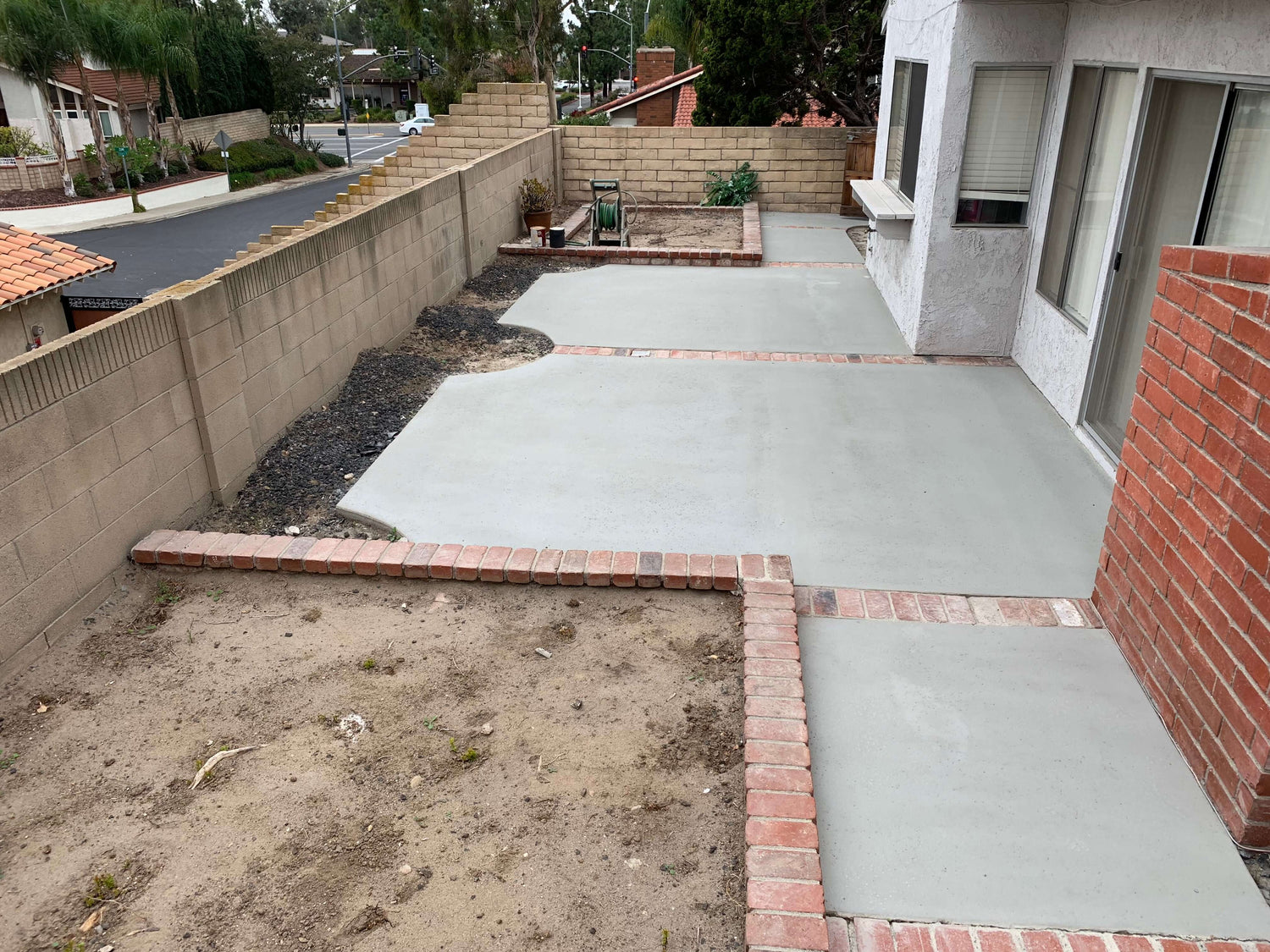 Backyard patio renovated with Like-Nu Concrete Restoration Kit, showcasing smooth and newly restored concrete surfaces.