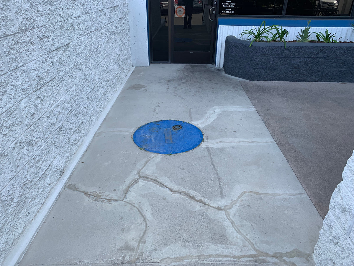 Cracked, mismatched concrete repair before Like-Nu restoration