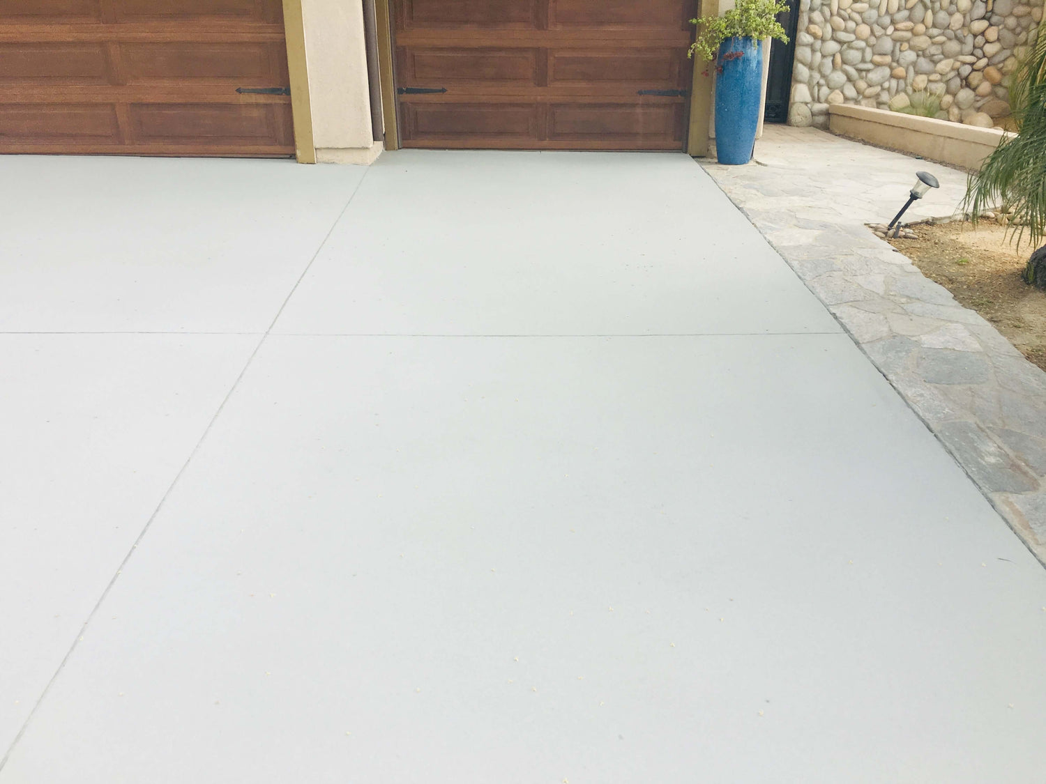 Freshly restored concrete driveway using Like-Nu Concrete Restoration Kit for driveway repair.