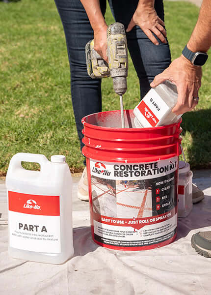 Mixing Like-Nu Concrete Restoration Kit in a red bucket with tools for easy concrete repair and restoration.