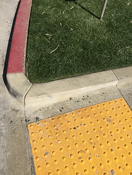 Close-up of a concrete restoration project on a curb and sidewalk by Like Nu Concrete Restoration Commercial Services.