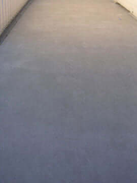 Freshly resurfaced concrete walkway showing smooth, even finish.